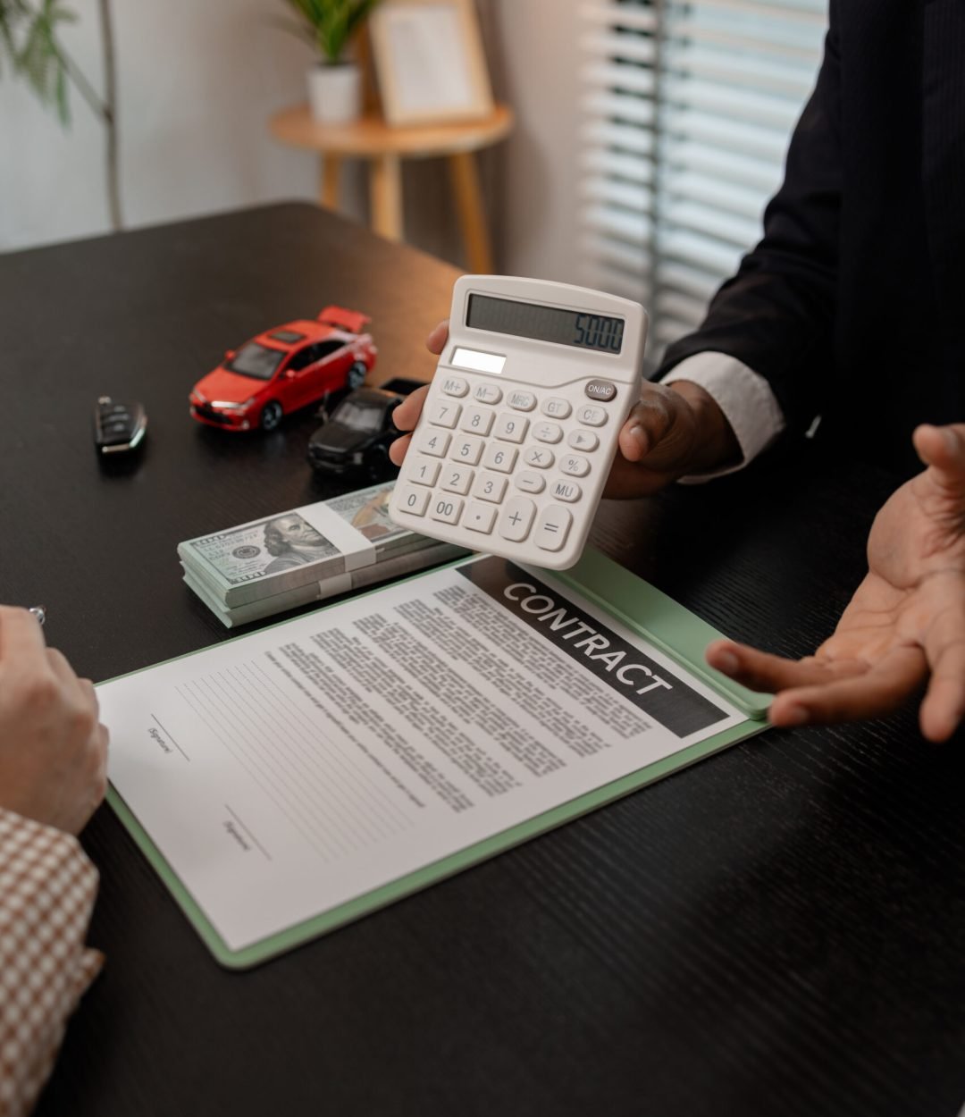 a car salesman is explaining the details of a car and the pricer that a buyer is interested in, the showroom sales manager explained the amount of interest